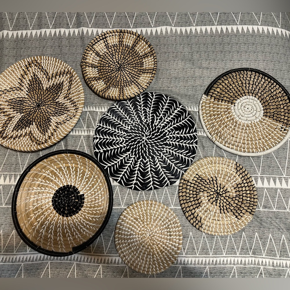 Set of seven flat baskets for a gallery wall.